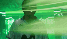 a man in a kappa shirt is surrounded by green light