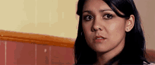 a close up of a woman 's face with a surprised look on her face