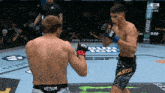 two men are fighting in a ring and one of them has the word venum on his underwear