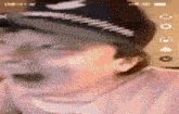 a close up of a person wearing a hat and laughing .