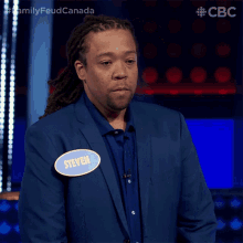 a man wearing a blue suit has a name tag that says steven
