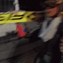 a blurry picture of a person holding a yellow sign that says ee