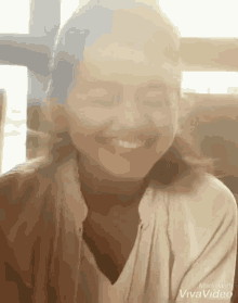 a woman is smiling with her eyes closed in a made with vivavideo video