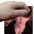 a hand is touching a man 's forehead in a pixel art .