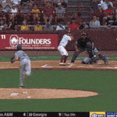 a baseball game is being played in front of a banner for founders