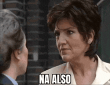 a woman talking to another woman with the words na also written on her face