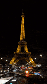 the eiffel tower lit up at night in paris