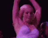 a group of people are watching a pole dancer perform