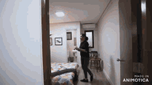 a woman is standing in a bedroom with the words made in animatica on the door
