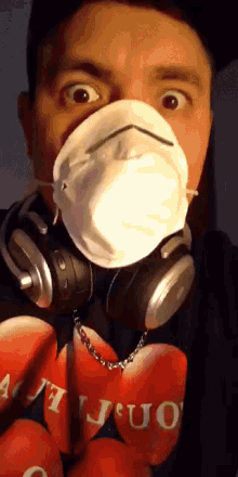 a man wearing headphones and a face mask has a shirt that says ' i love you ' on it