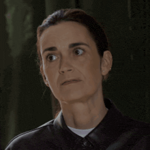 a close up of a woman making a surprised face