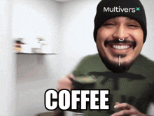 a man wearing a beanie that says multivers is drinking a cup of coffee