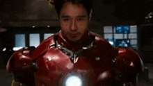 a close up of a man wearing a red and gold iron man suit and helmet .
