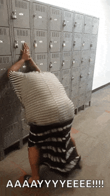 a person standing in front of a row of lockers with a caption that says " aaayyyeeee "