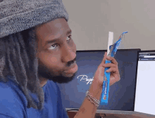 a man with dreadlocks is looking at a box of hormel s'mores
