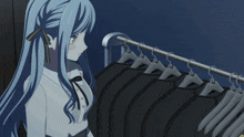 a woman with long blue hair is looking at clothes