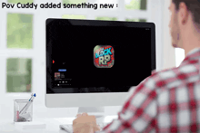 a man sits in front of a computer screen that says the block r9