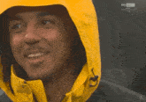 a man wearing a yellow jacket with a hood is being shown on sky sport live