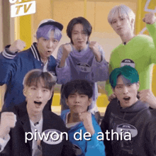 a group of young men are posing for a picture and one of them is wearing a name tag that says piwon de athia