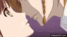 a couple of anime characters are kissing each other on a bed .
