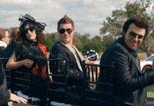 a group of people are sitting in chairs and one of them has sunglasses on