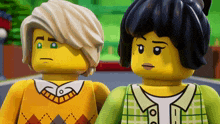 two lego figures are standing next to each other