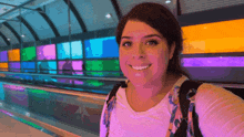 a woman taking a selfie in front of a stained glass wall