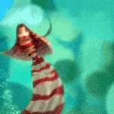 a woman in a red and white striped dress is standing in front of a blue background
