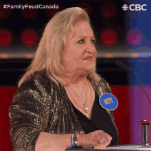 a woman sitting at a table with a name tag that says betty