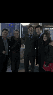 a group of people posing for a picture in front of a sign that says doctor