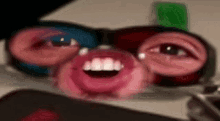 a close up of a person 's face with glasses and a smiley face .