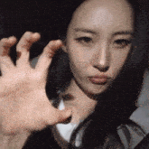 a close up of a woman 's face and hand
