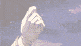 a pixelated image of a person 's hand pointing to something