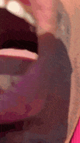 a close up of a person 's mouth with a pink lipstick on