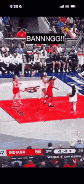 a basketball game is being played on a court with a crowd watching .