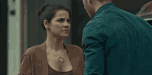 a man and a woman are looking at each other and talking .