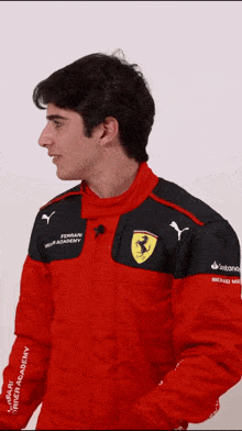 a man is wearing a red jacket with ferrari on it