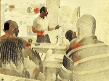 a man is giving a presentation to a group of people in a room