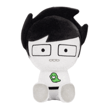 a black and white stuffed toy with a green worm on his chest