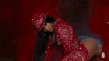 a woman wearing a red cowboy hat and a red jacket .