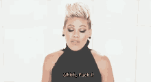 a woman in a black dress is making a funny face and saying `` uhhh , fuck it '' .