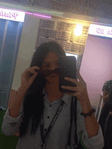 a girl taking a picture of herself with a lanyard that says number one
