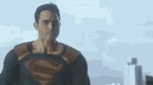 a man in a superhero costume is pointing at the camera .