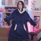a woman wearing headphones and a blue blanket with the word ren on it