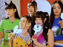 a group of girls are posing for a picture and one has a shirt that says rose on it
