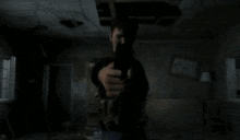 a man is standing in a dark room with a fireball in his hand