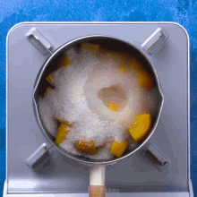 a pot filled with sliced fruit and sugar on a stove with the words mr. cakes below it