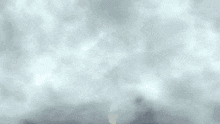 a person is falling from a cliff with a sword in their hand .