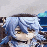 a close up of a figurine with blue hair