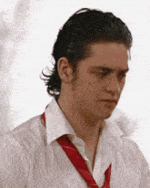a man wearing a white shirt and red tie